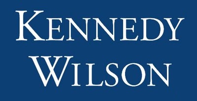 A logo with the text "Kennedy Wilson" in white on a blue background, representing excellence in commercial parking management.