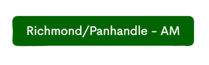 A green sign with white text that reads, "Richmond/Panhandle - AM," guiding drivers to available visitor parking.