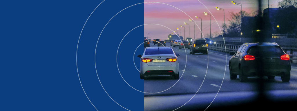Cars driving on a multi-lane highway during dusk, with a blue overlay on the left side of the image featuring circular radar waves, reminiscent of commercial parking lot systems enhancing traffic flow and safety.