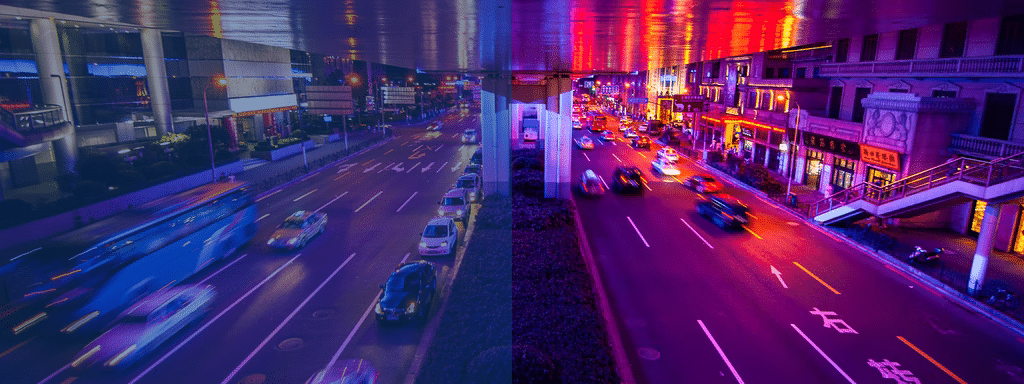 A city street at night is divided into two. The left side is blue-tinted with moderate traffic and efficient parking management, while the right side is purple-tinted, showing heavier traffic and more vibrant building lights.