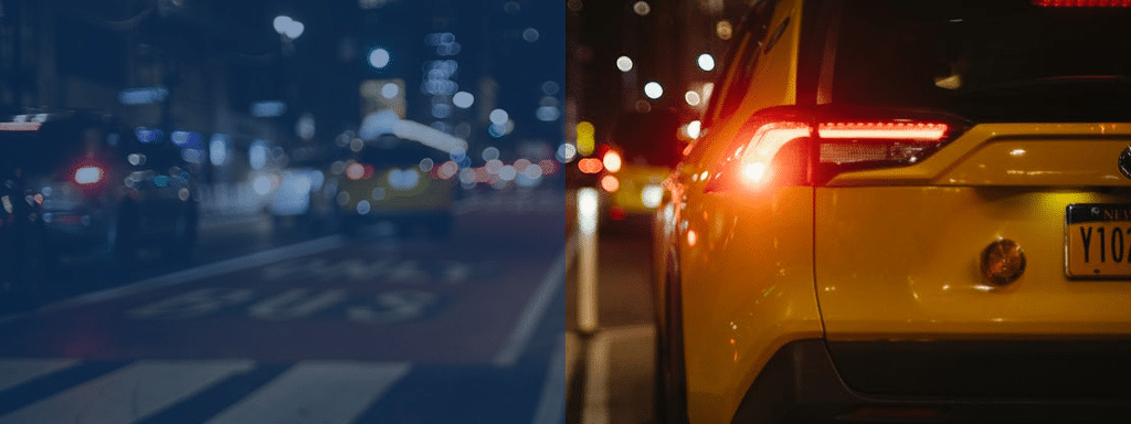 Rear view of a yellow taxi with lit taillights on a city street at night, blending seamlessly into the bustling scene enhanced by parking management efforts, with blurred vehicles and streetlights in the background.