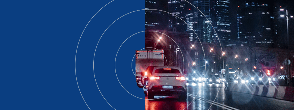 Side-by-side split image showing cars on a city street at night; the left side is untreated, while the right side, featuring a commercial parking lot system by wayleadr, has enhanced lighting and reflections. Concentric circles overlay the right side.