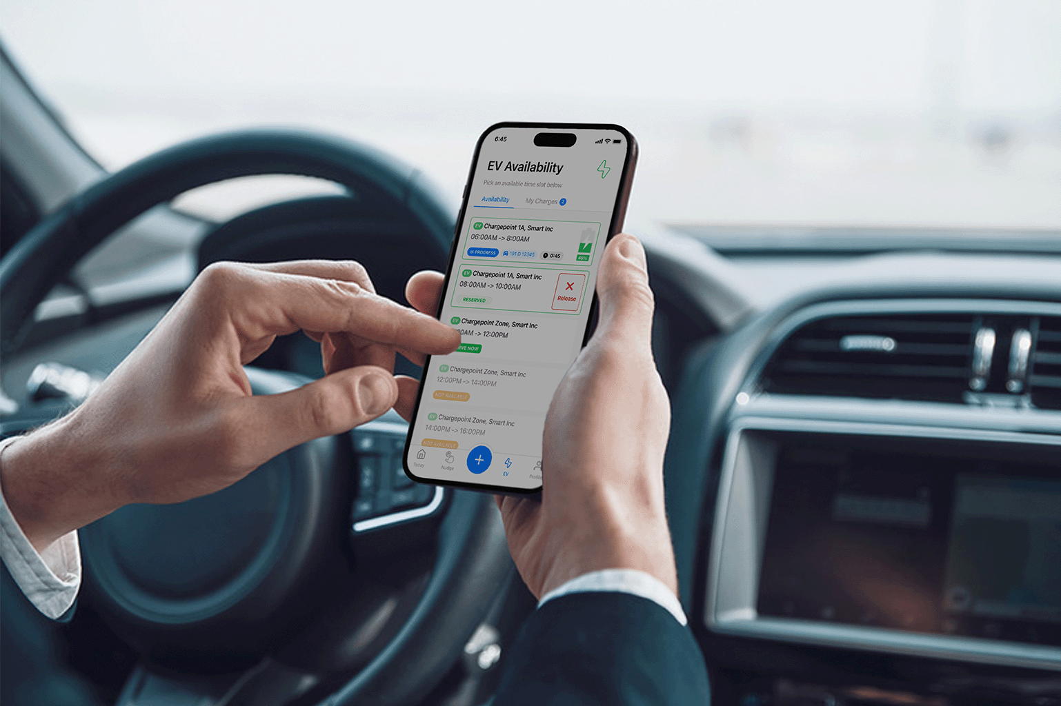 A person in a car selects a location from an EV availability app on a smartphone, showing options for charging stations nearby.