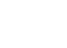 White "Fernie Tourism" logo with a stylized maple leaf accent over the letter "i," displayed on a light gray background.
