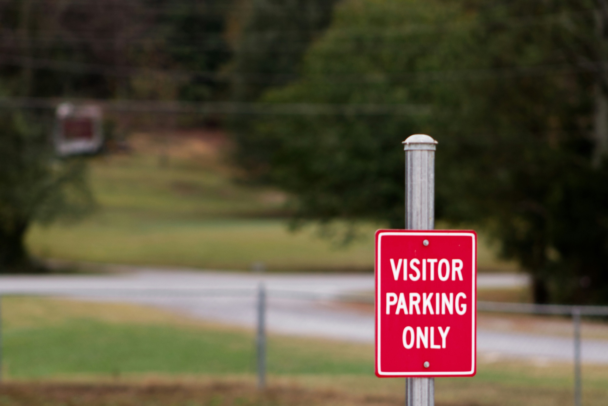 Red "Visitor Parking Only" sign marking a designated guest parking area